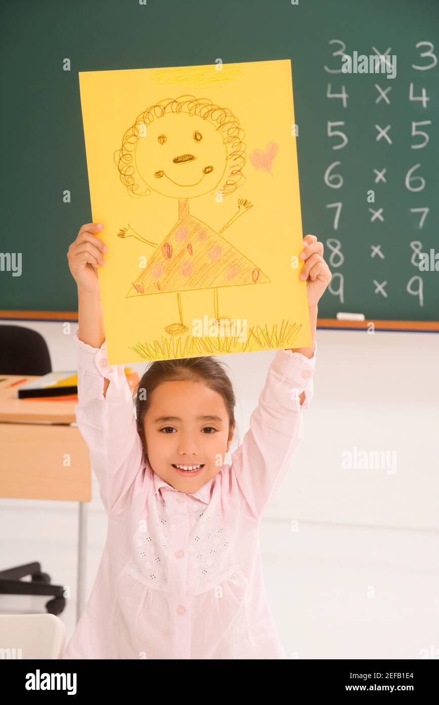 Portrait of a schoolgirl showing her drawing and smiling Stock Photo ...