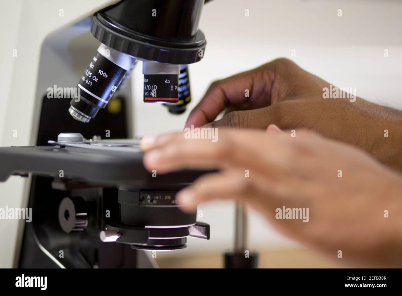Scientist examines with Microscope Stock Photo