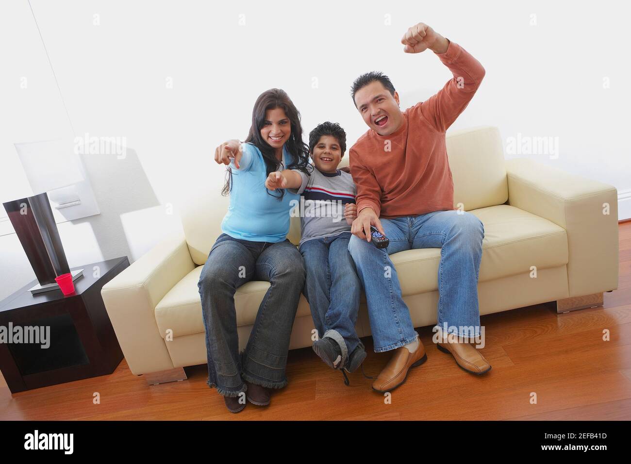 Portrait of a mid adult man and a young woman sitting with their son on ...