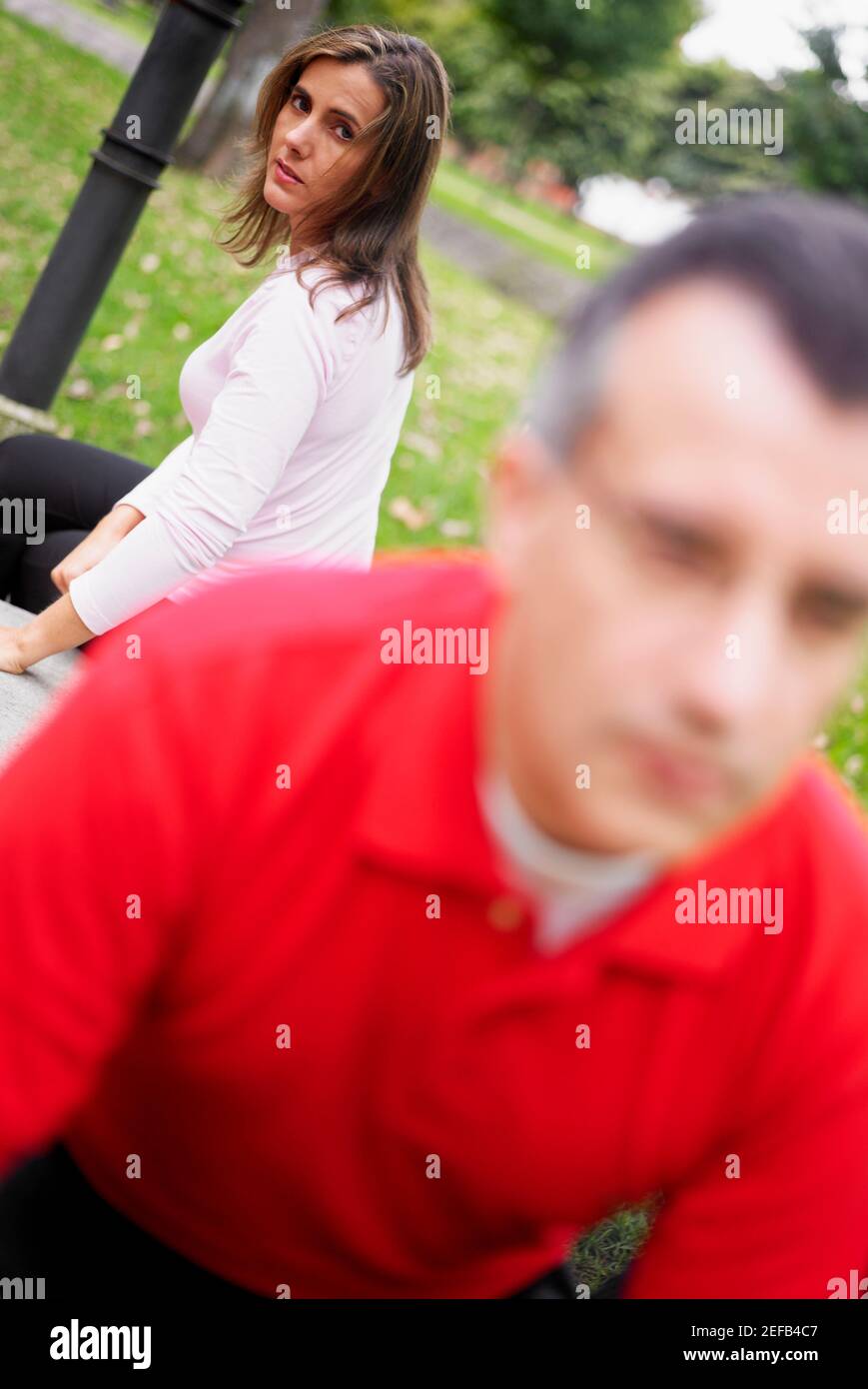 Portrait of a mid adult woman sitting behind a mid adult man Stock ...