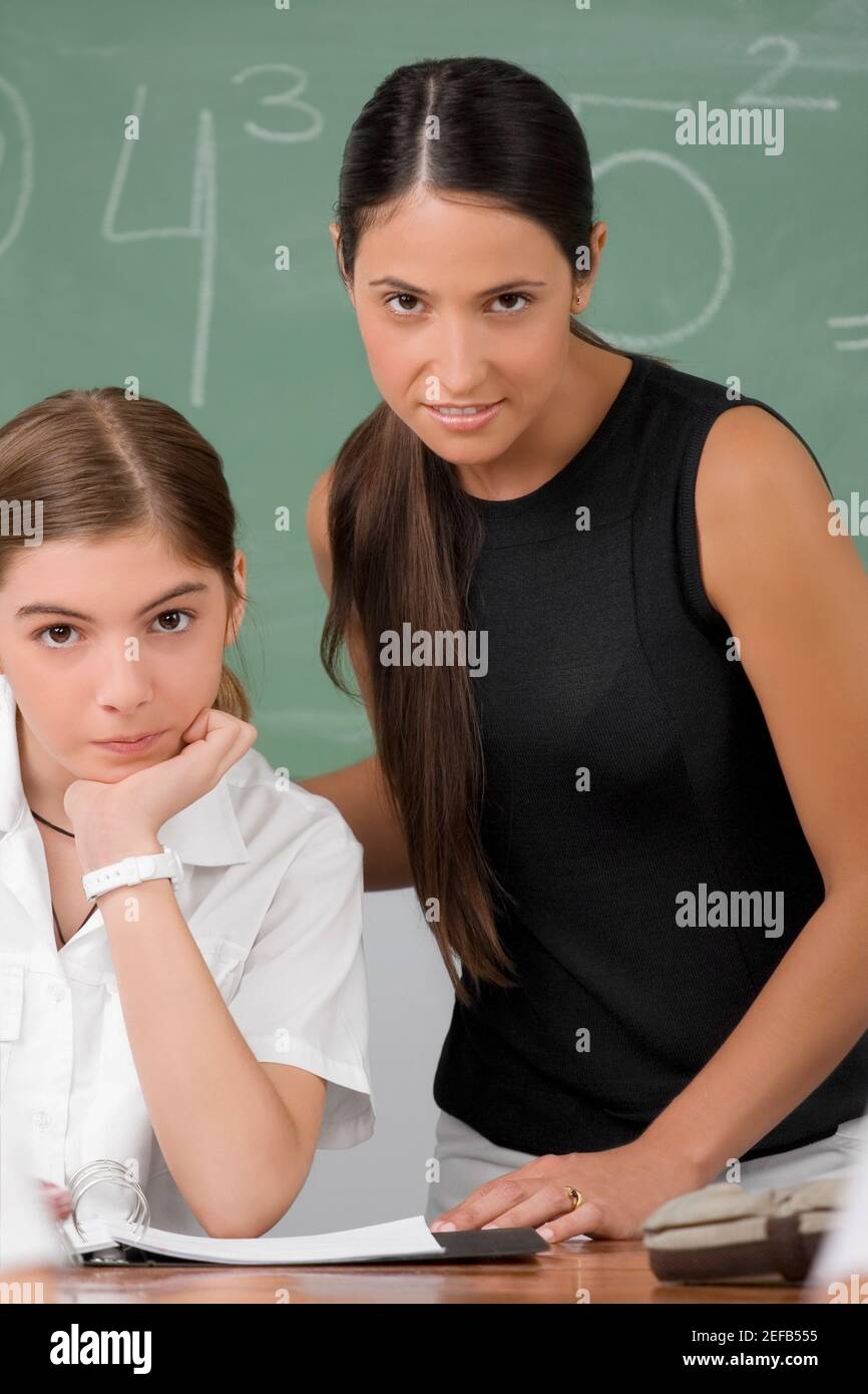 Portrait of a female teacher with a schoolgirl in a classroom Stock ...