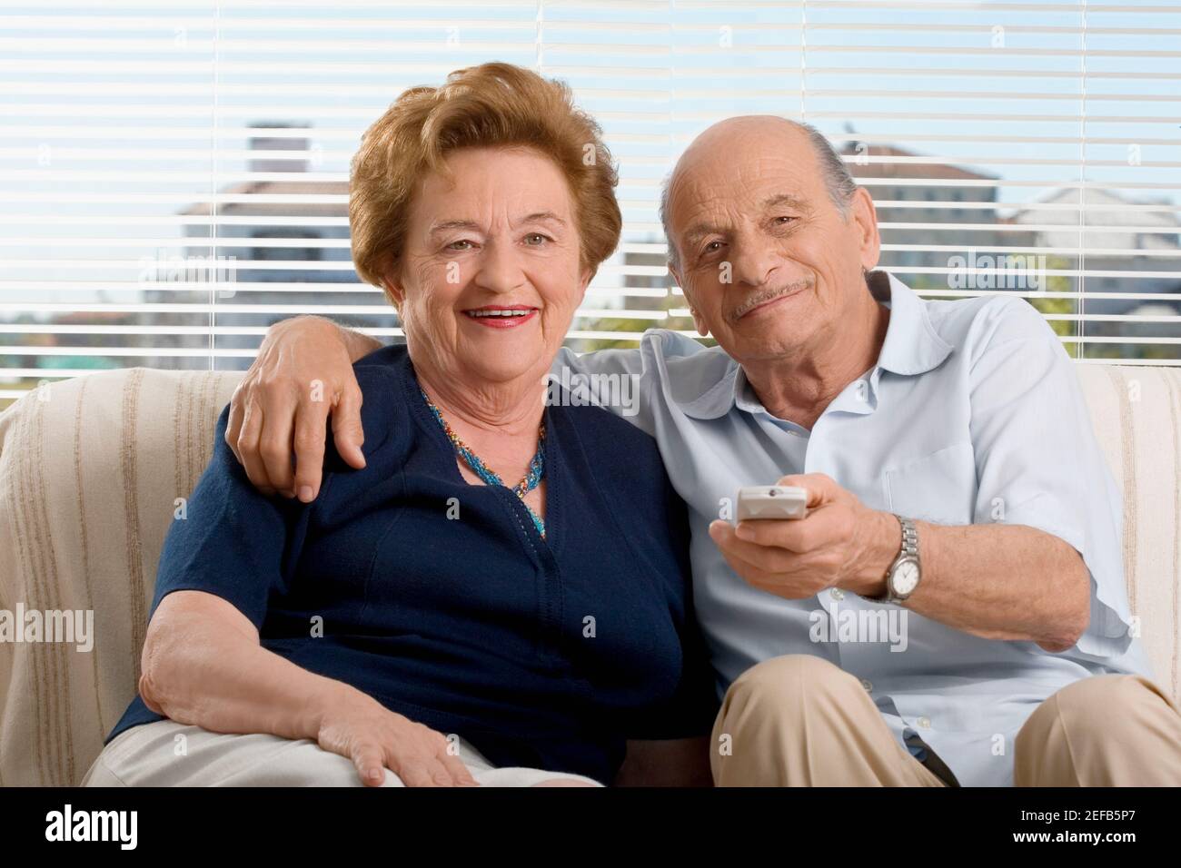 Portrait of a senior couple watching television Stock Photo