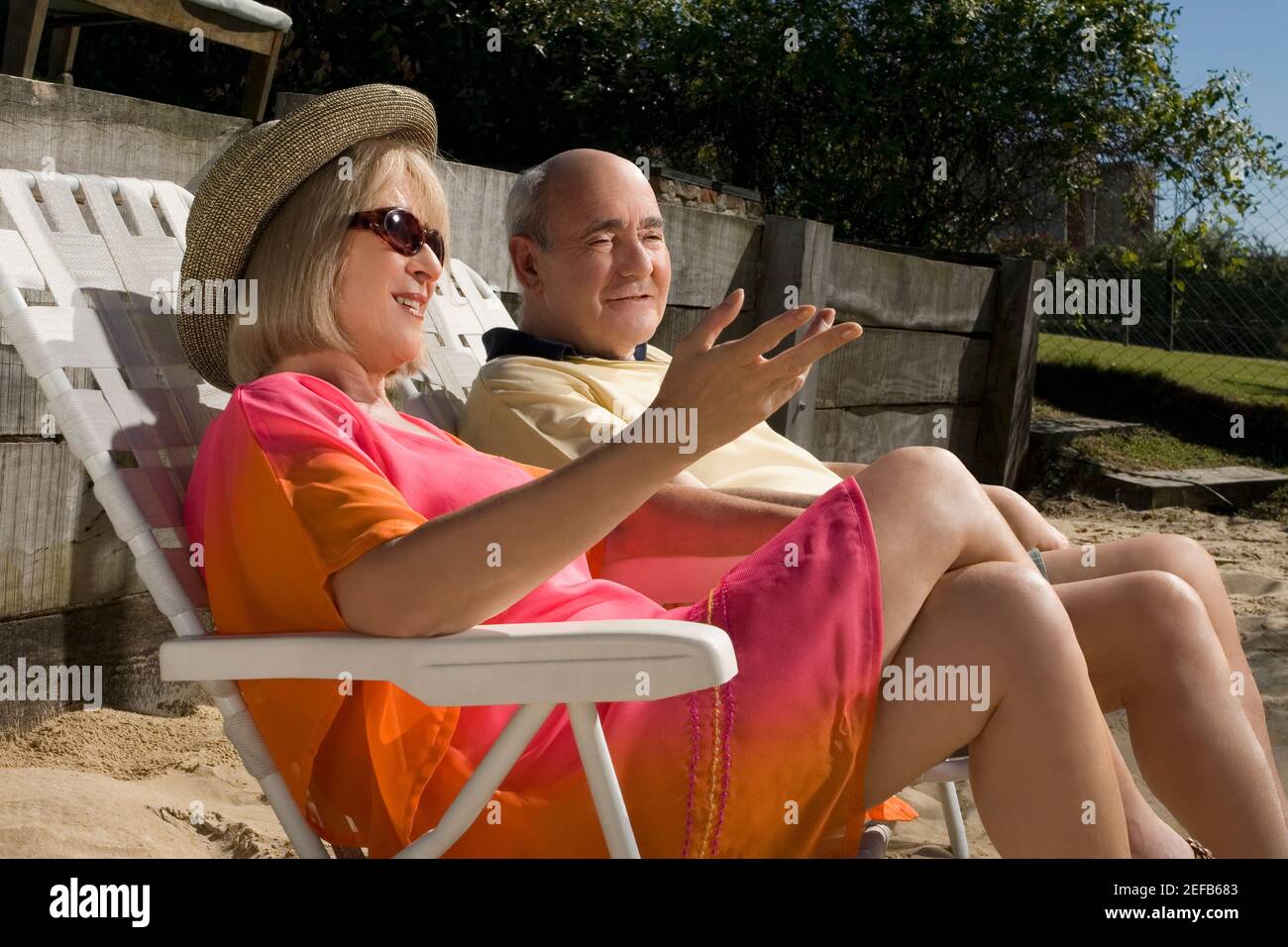 Senior couple sitting on chairs Stock Photo