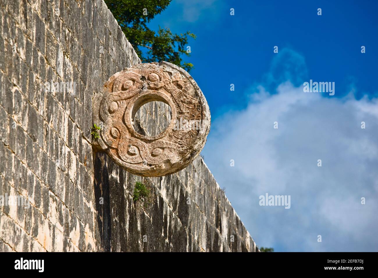 Circular carved stone on the wall, Ball Court Ring, Chichen Itza, Yucatan, Mexico Stock Photo