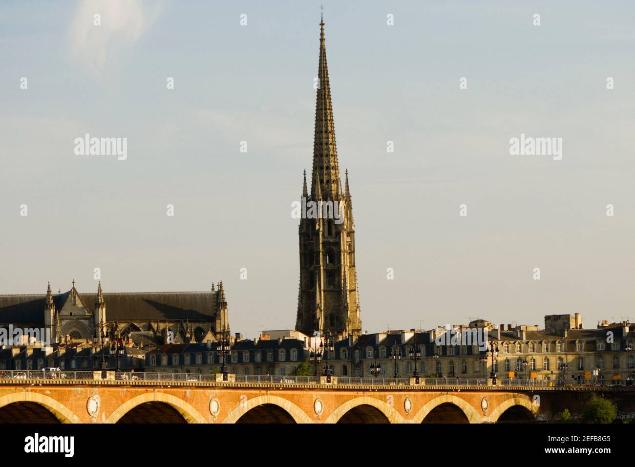 Arch bridge over a river, Pont De Pierre, St. Michel Basilica, Garonne River, Bordeaux, Aquitaine, France Stock Photo