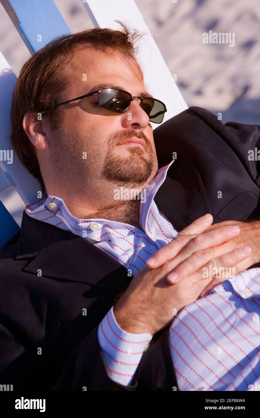 Man sleeping on lounge chair hires stock photography and images Alamy