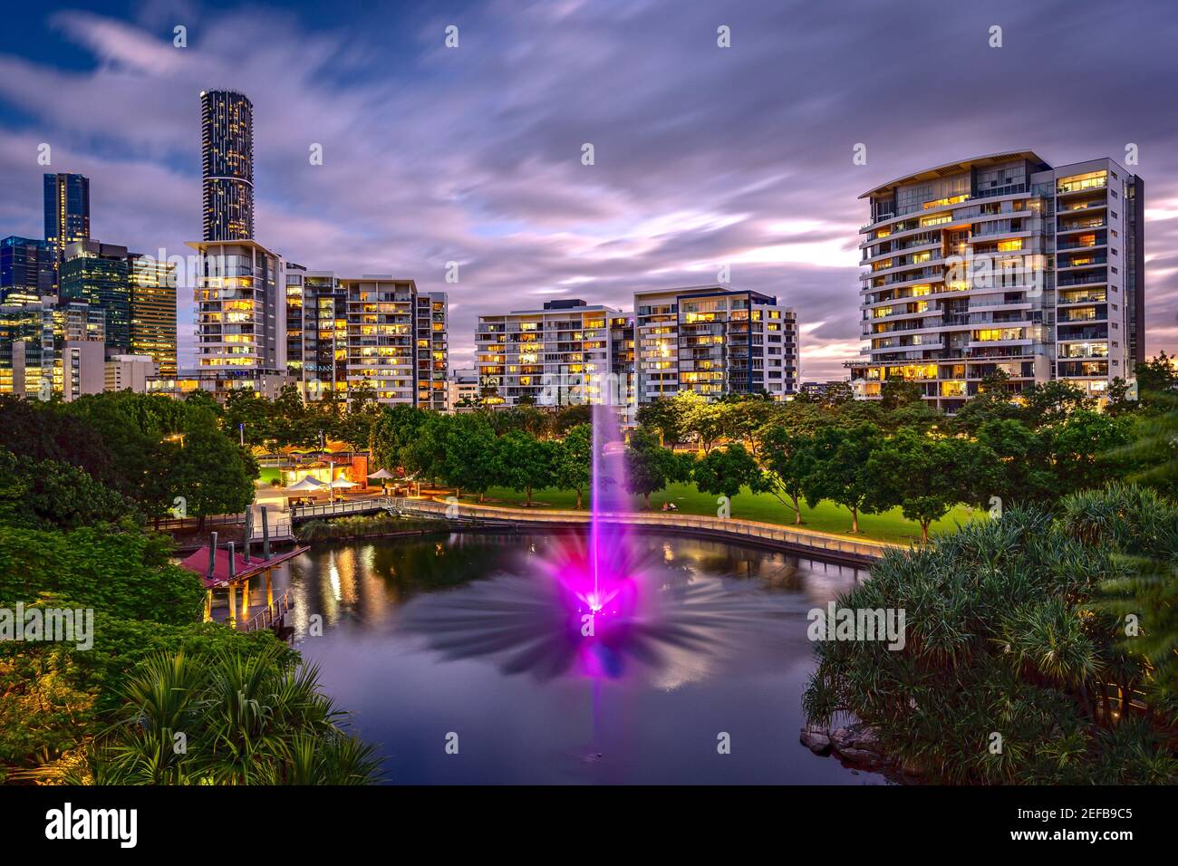 Residential apartment buildings around the Roma Street Parkland with illuminated fountain, Brisbane, Australia Stock Photo