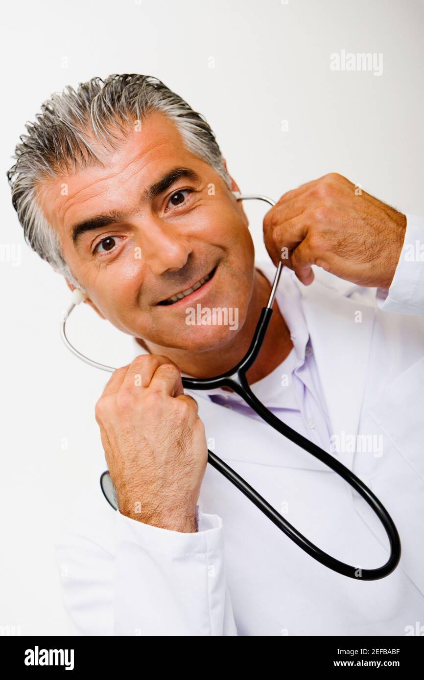 Portrait of a male doctor holding a stethoscope and smiling Stock Photo ...