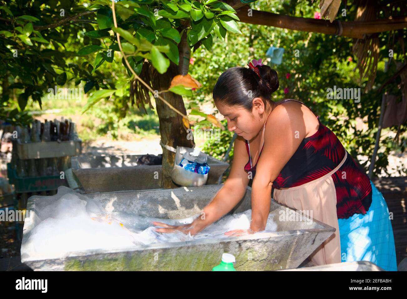 Young woman washing clothes, Papantla, Veracruz, Mexico Stock Photo