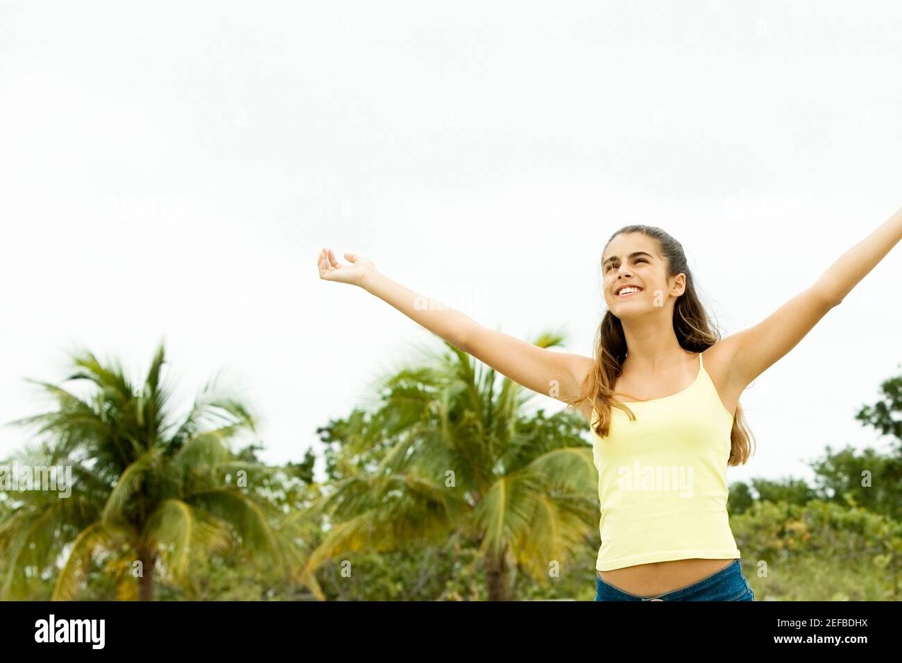 Girl standing with her arms outstretched Stock Photo - Alamy