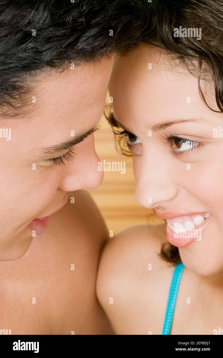 Close-up of a young man and a teenage girl facing each other Stock ...