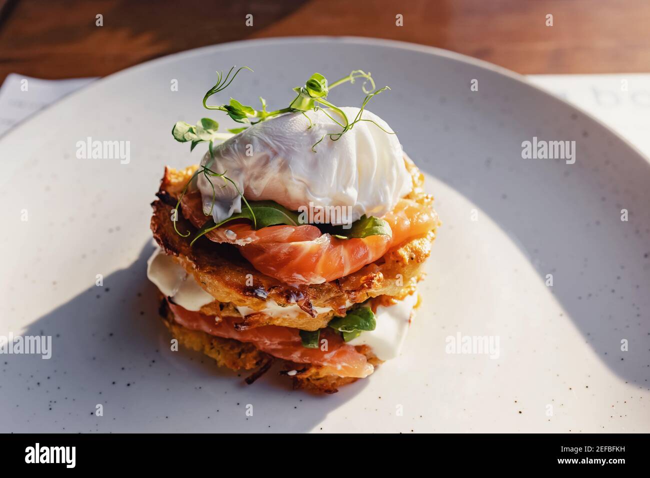 Stack of hash brown with salmon and poached egg on the top Stock Photo Alamy