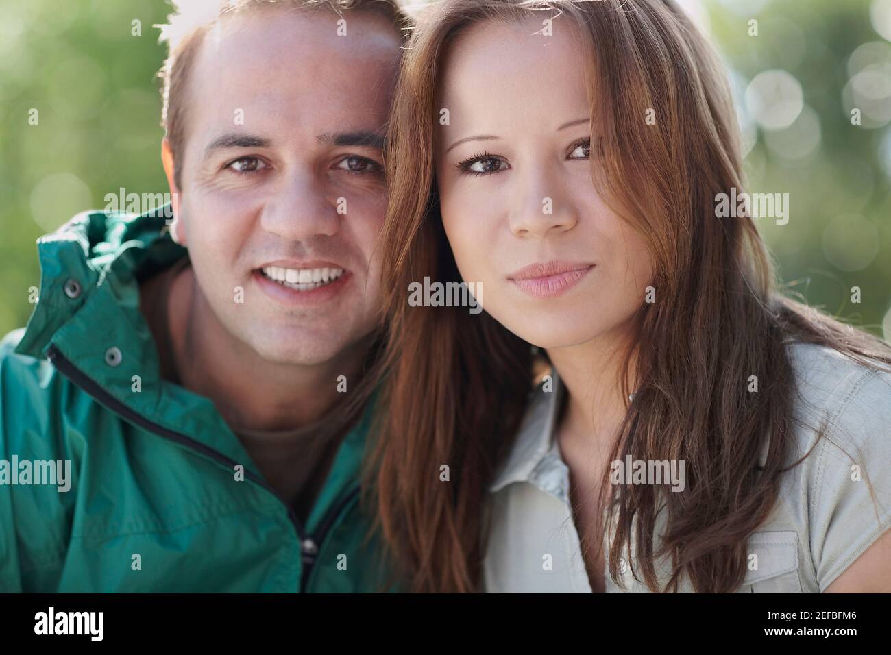 Portrait of a mid adult man and a young woman smiling Stock Photo