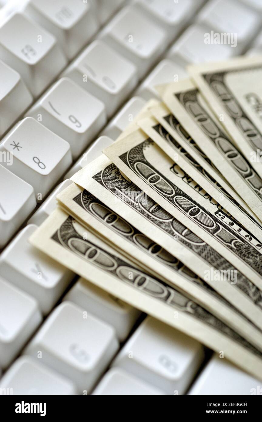United States one hundred dollar bills on top of computer keyboard ...