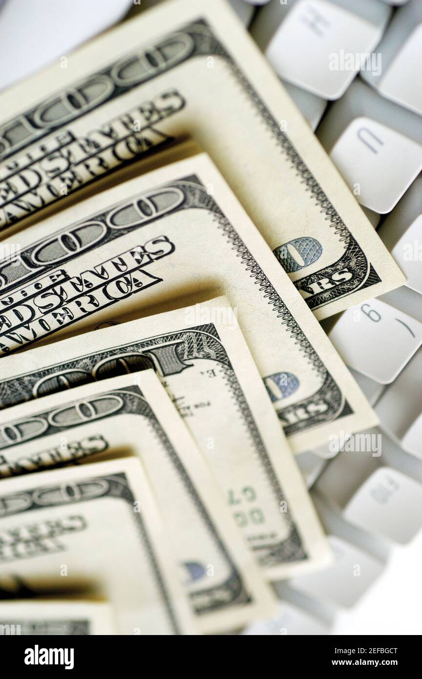 United States one hundred dollar bills on top of computer keyboard ...
