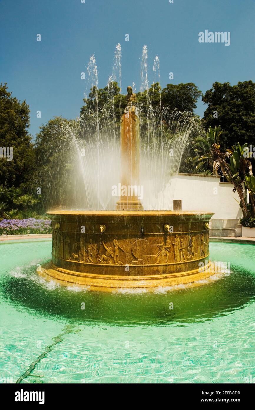 Ornate stone fountain spouting water Stock