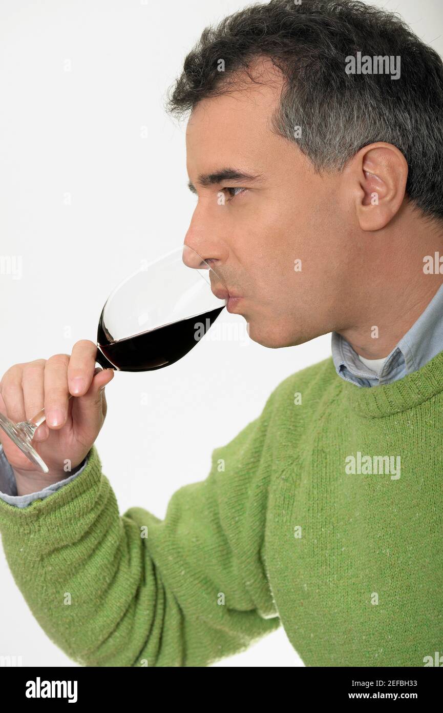 Close-up of a mid adult man drinking red wine Stock Photo - Alamy