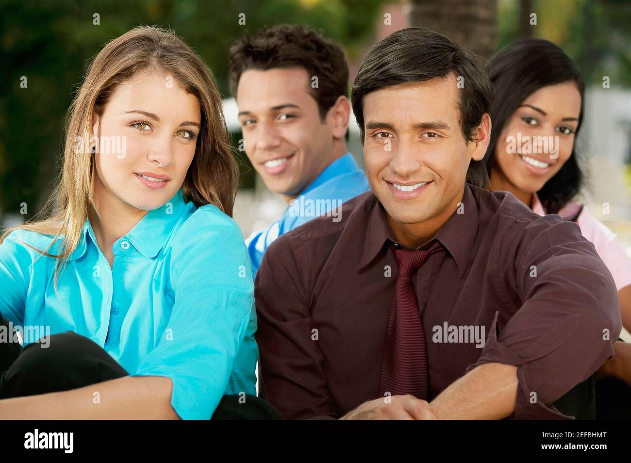 Portrait of two young men and two young women smiling Stock Photo - Alamy