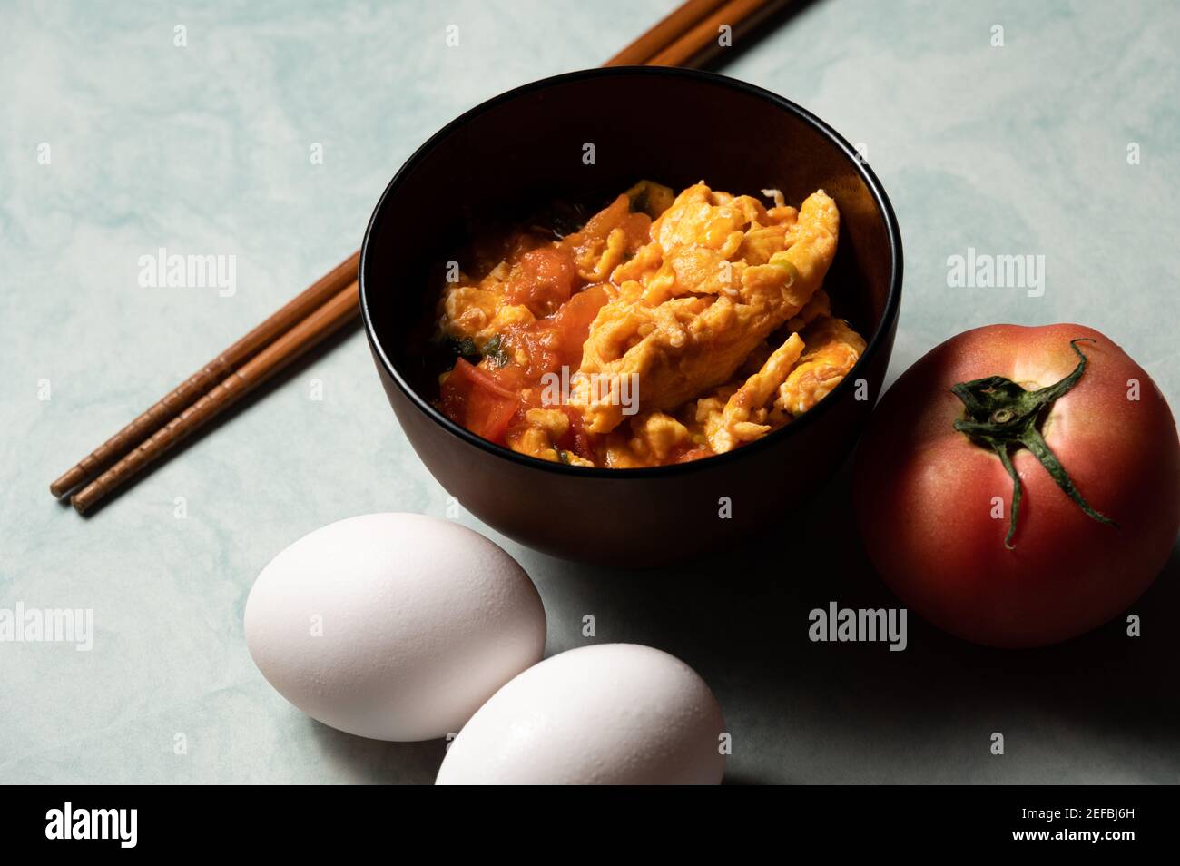Scrambled eggs with tomatoes is a home cooked meal in Taiwan,China and other east asia area.Scrambled eggs with boiled tomatos,based with tomato sauce Stock Photo