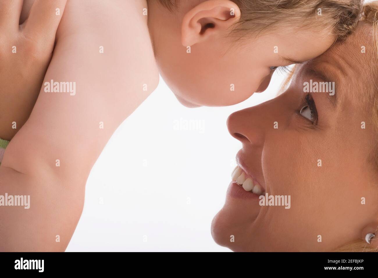 Close up of a mid adult woman looking at her son and smiling Stock Photo