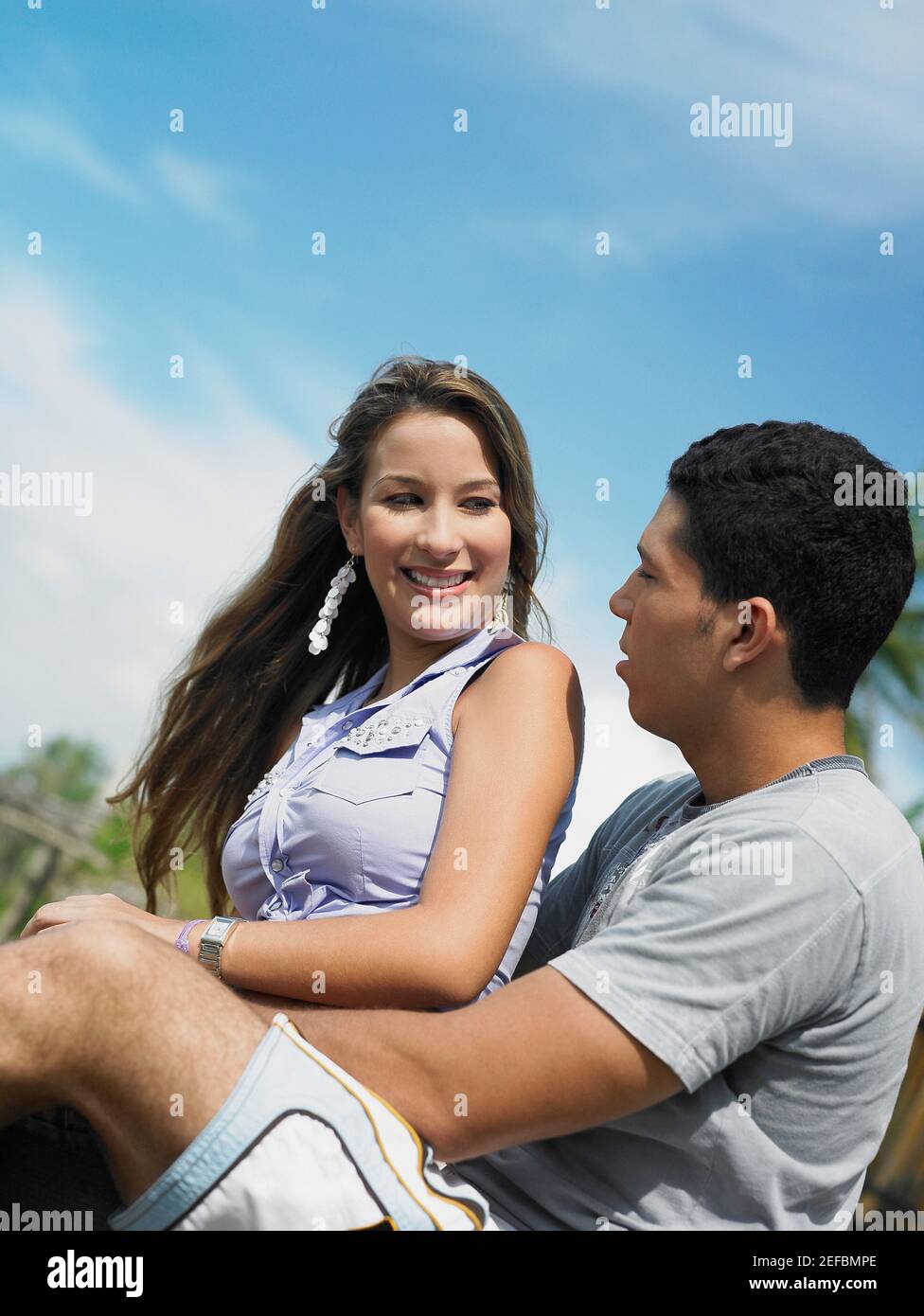 Side profile of a young man embracing a young woman from behind Stock ...