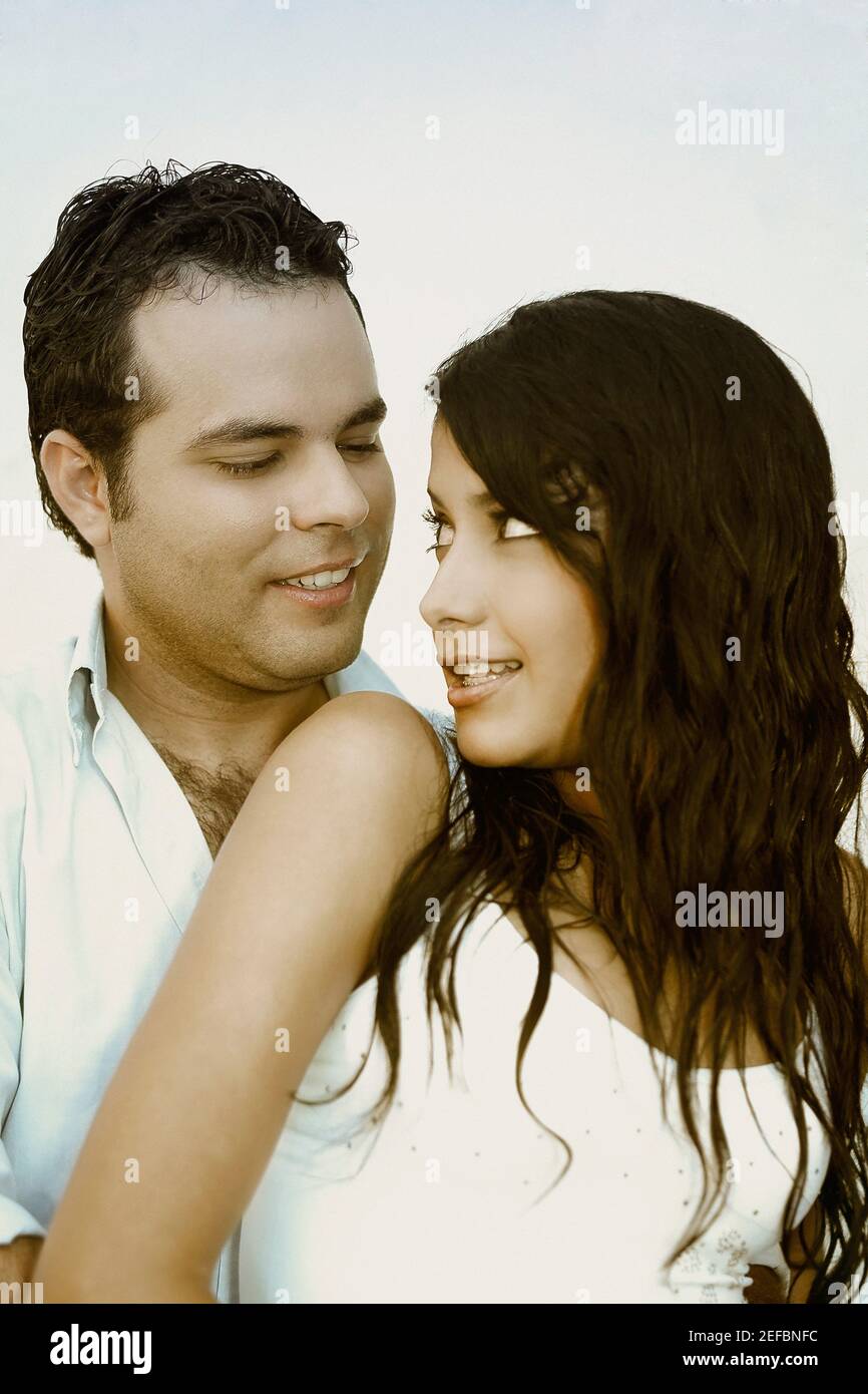 Close up of a young man embracing a young woman from behind Stock Photo ...