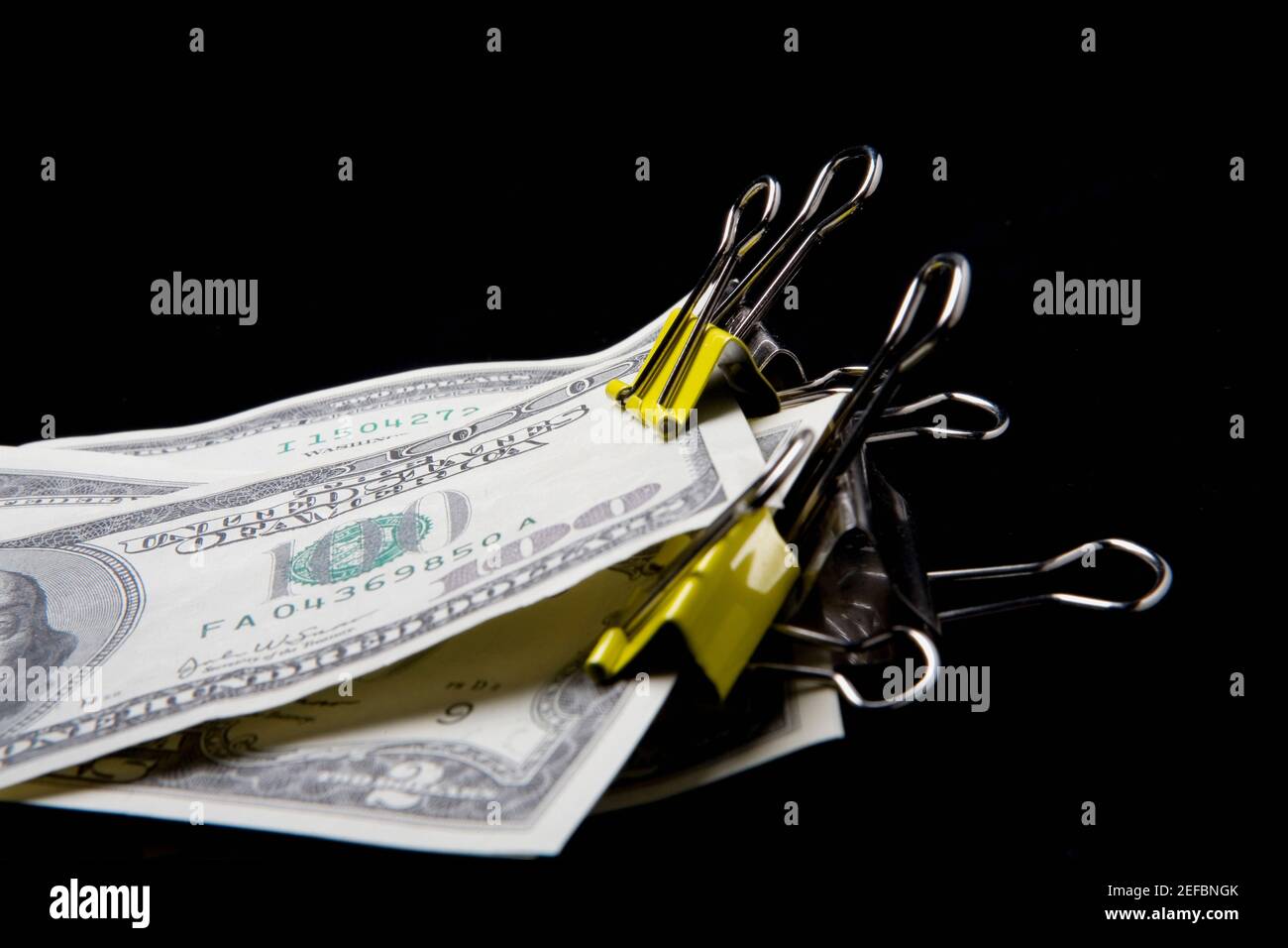 Dollar bills in binder clips Stock Photo Alamy