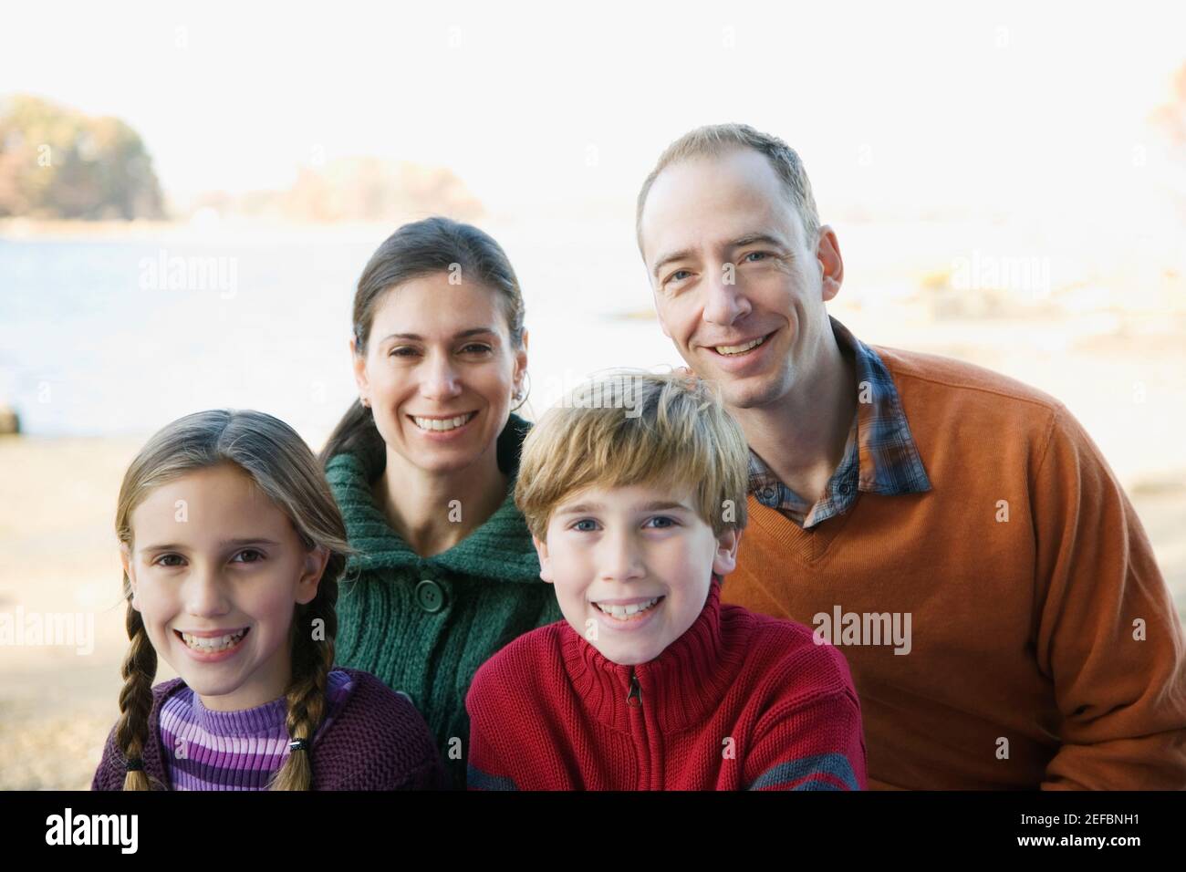 Portrait of a mid adult couple with their two children Stock Photo