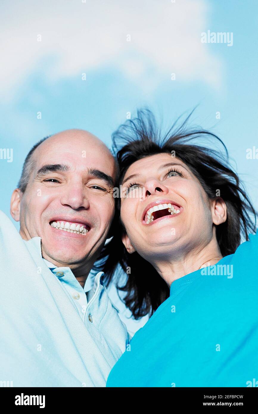 Low angle view of mature couple with their arms raised Stock Photo