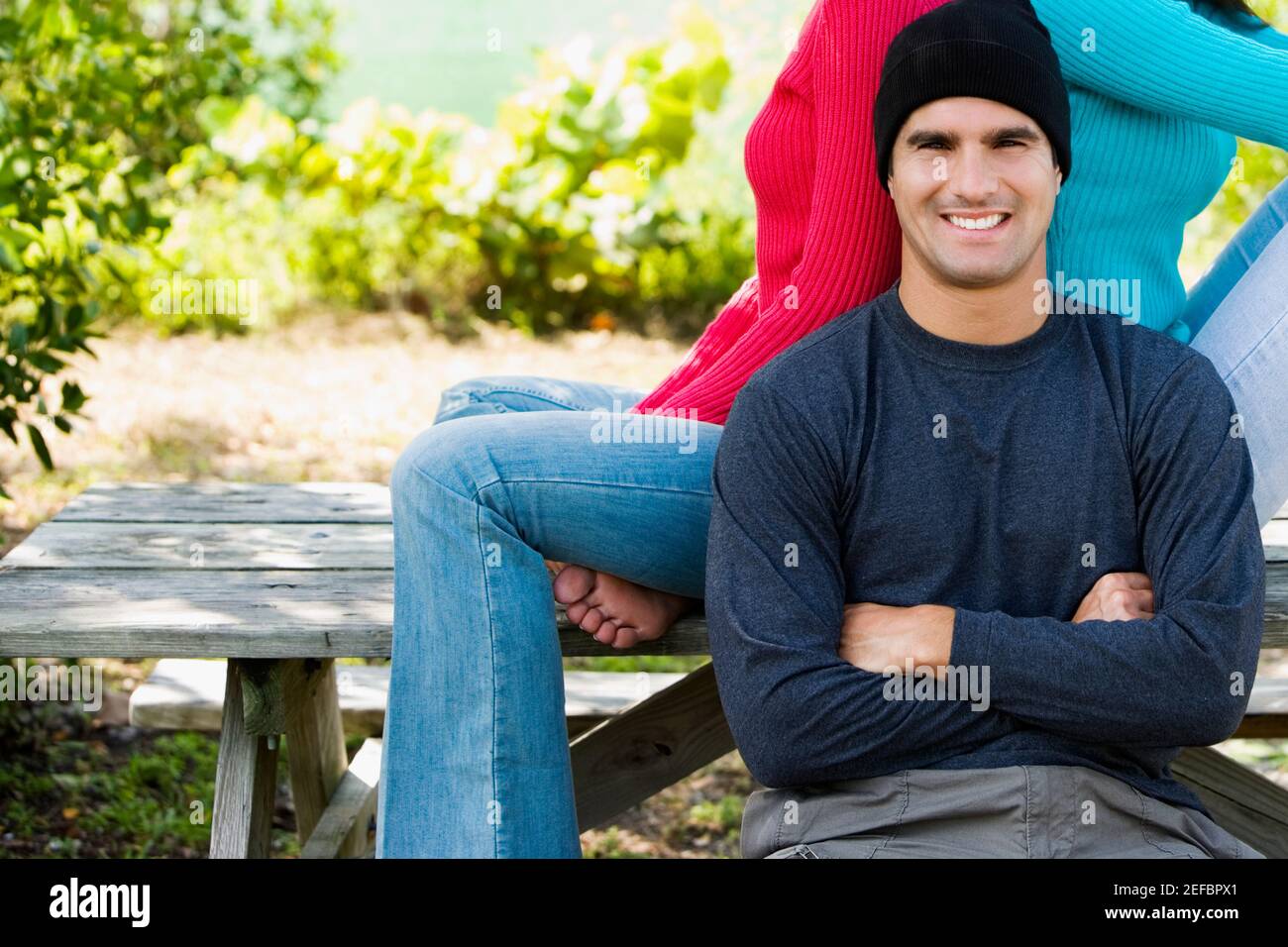 Portrait of a mid adult man sitting in front of two young women Stock ...
