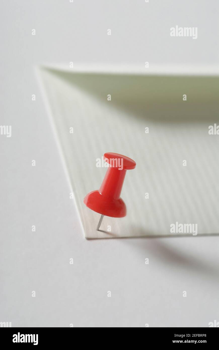 Thumbtack on paper Stock Photo Alamy