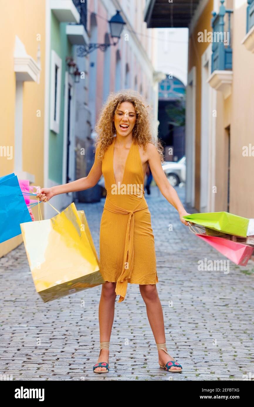 Portrait of a teenage girl standing in the street and holding shopping bags Stock Photo