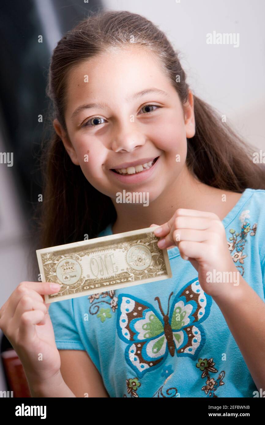 Portrait of a girl holding paper currency Stock Photo