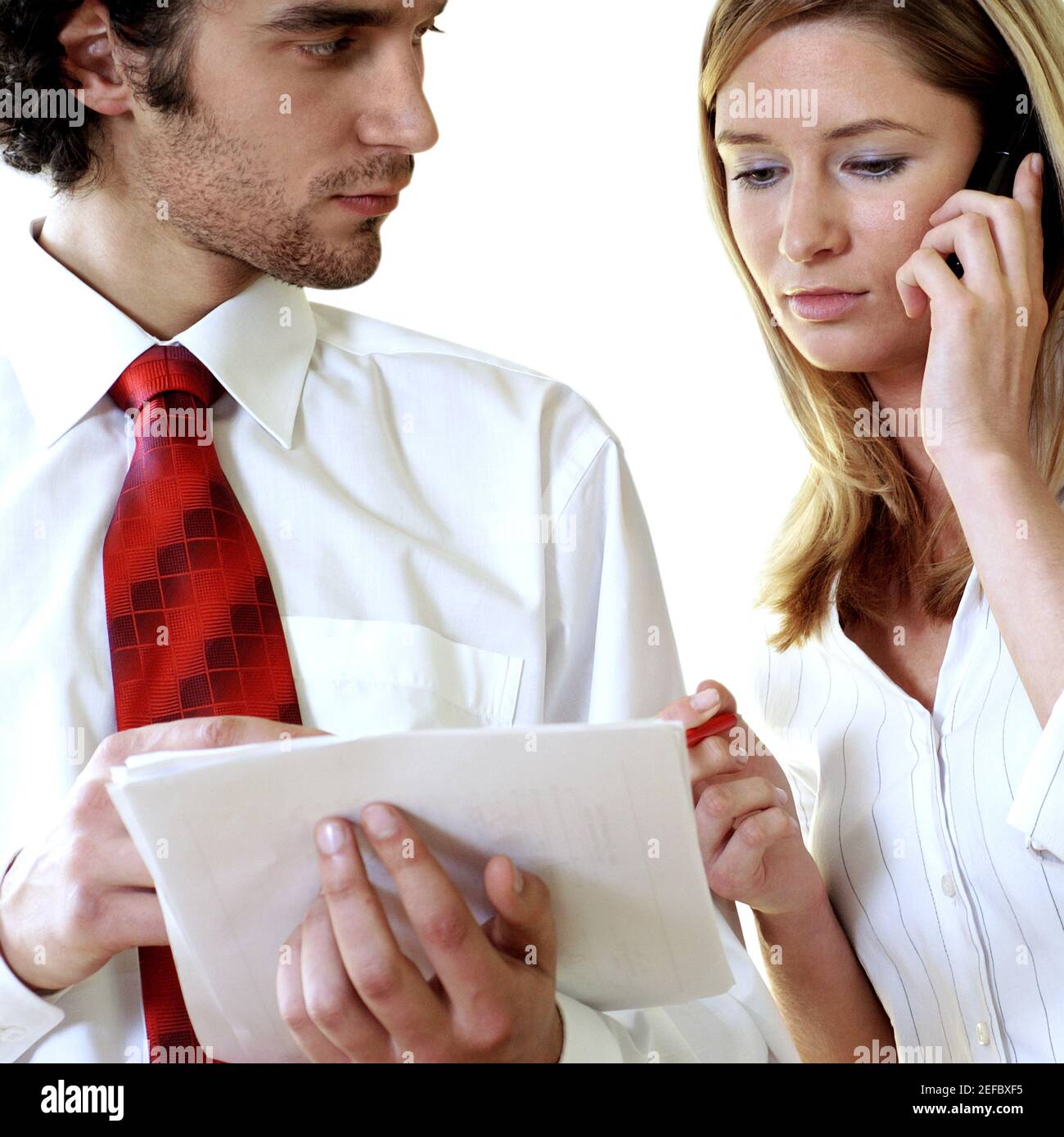 Businessman and a businesswoman discussing documents Stock Photo