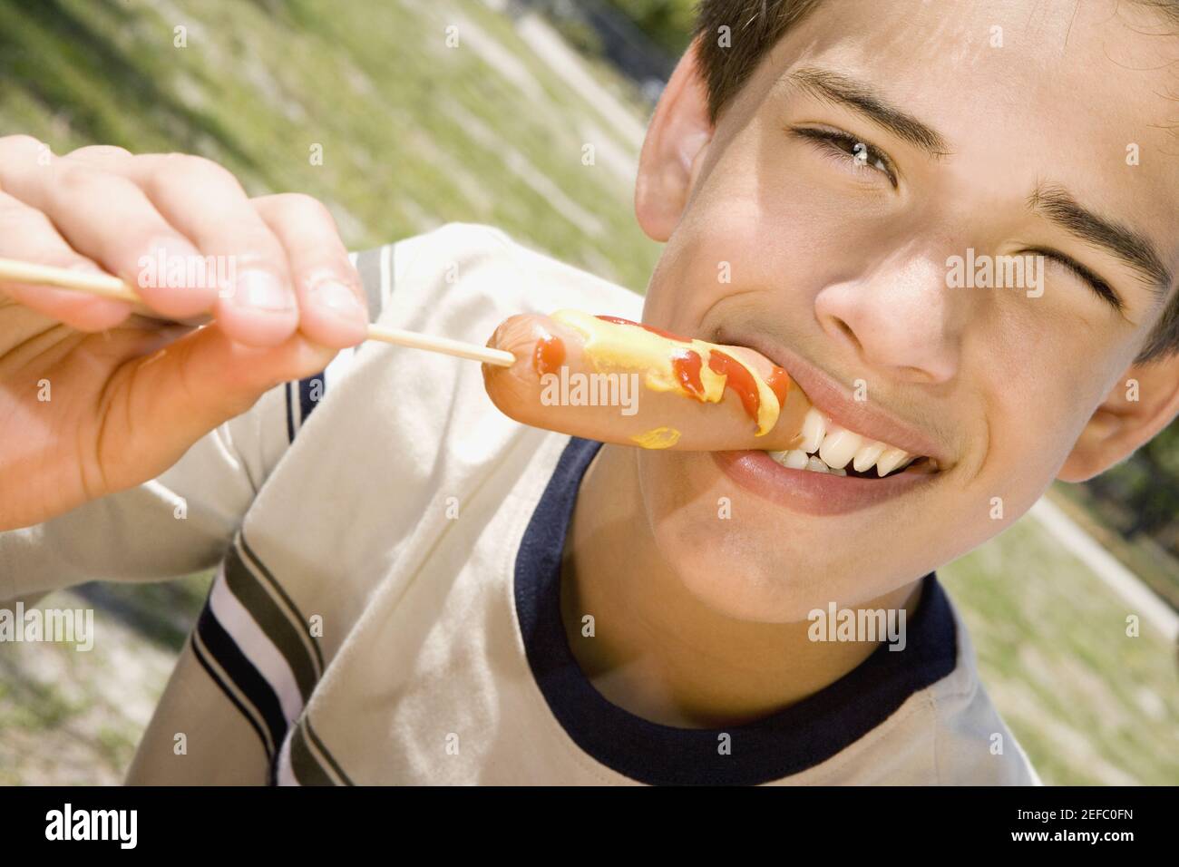 Portrait of a boy eating a sausage Stock Photo Alamy