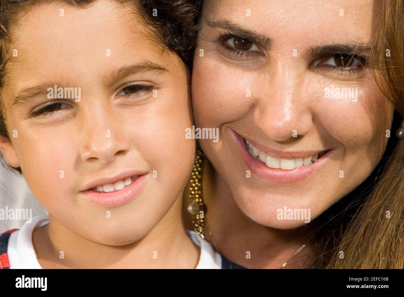 Portrait of a mid adult woman and her son smiling Stock Photo