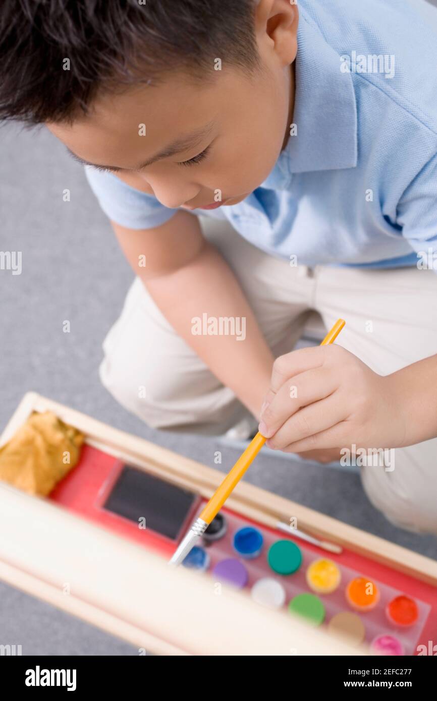 High angle view of a schoolboy painting in an art class Stock Photo - Alamy