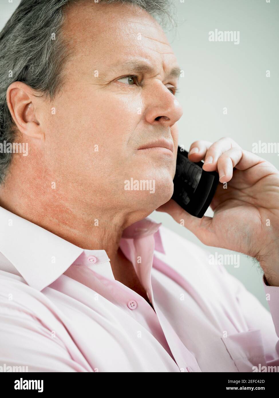 Close-up of a mature man holding on a mobile phone Stock Photo