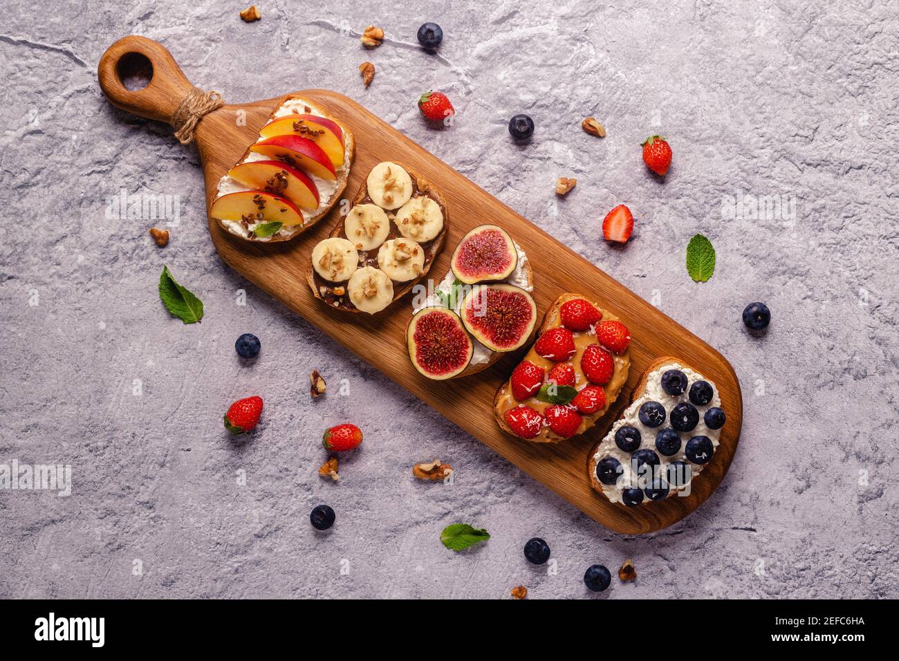 Homemade summer toast with cream cheese, nut butter and fruits and