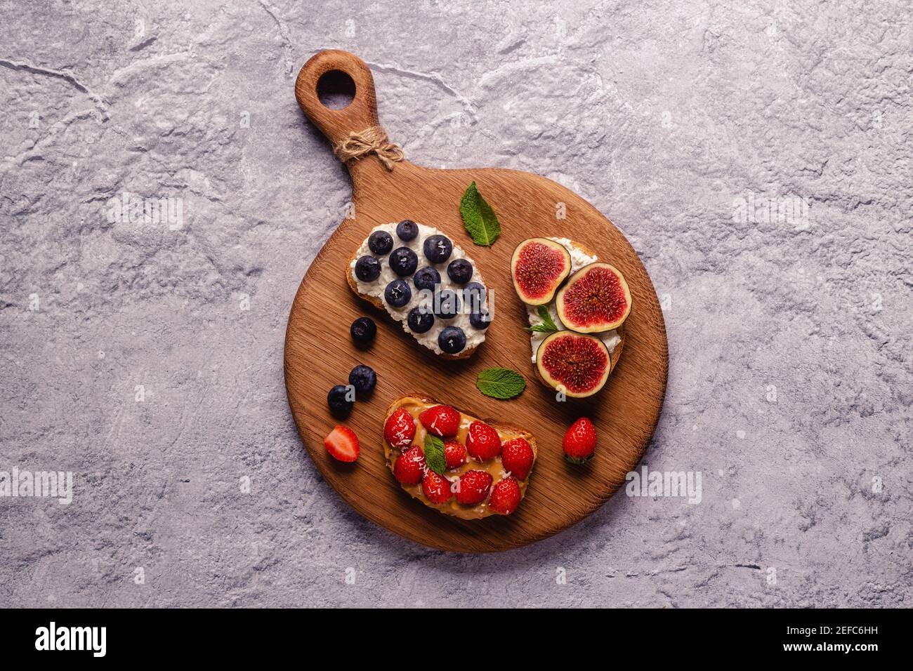 Homemade summer toast with cream cheese, nut butter and fruits and