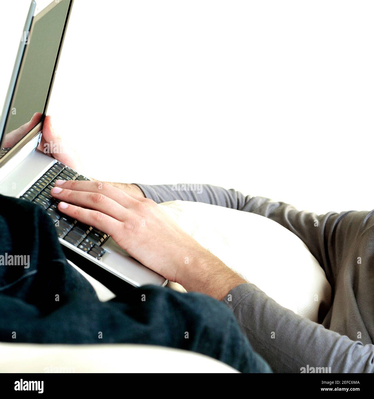 Mid section view of a man using a laptop Stock Photo - Alamy