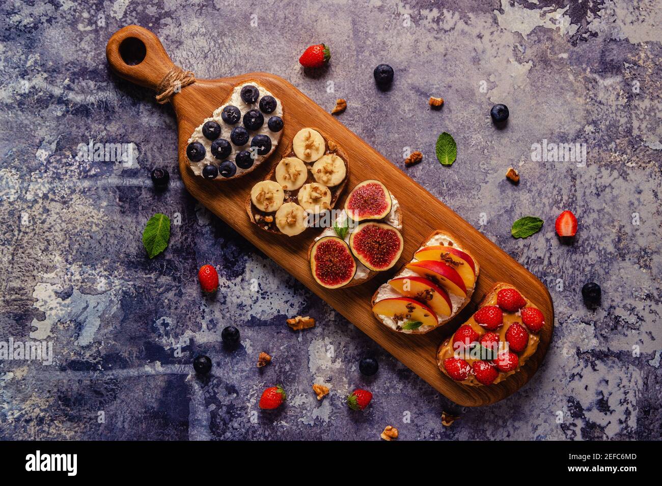 Homemade summer toast with cream cheese, nut butter and fruits and