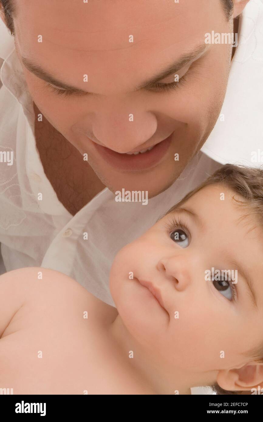 Close up of a young man smiling with his son Stock Photo