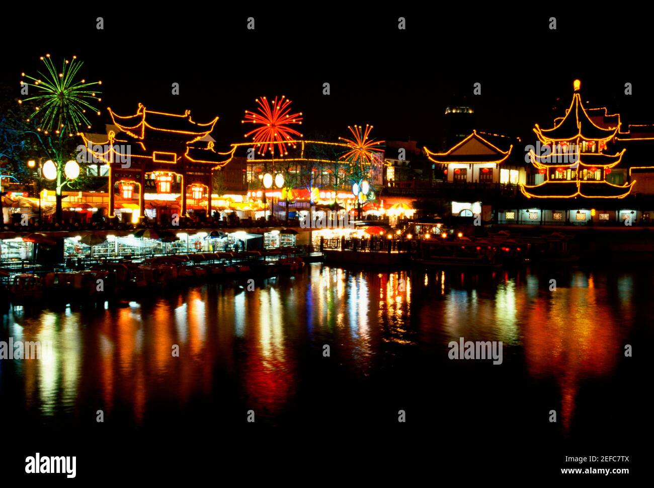 Buildings lit up at night, Nanjing, Jiangsu Province, China Stock Photo