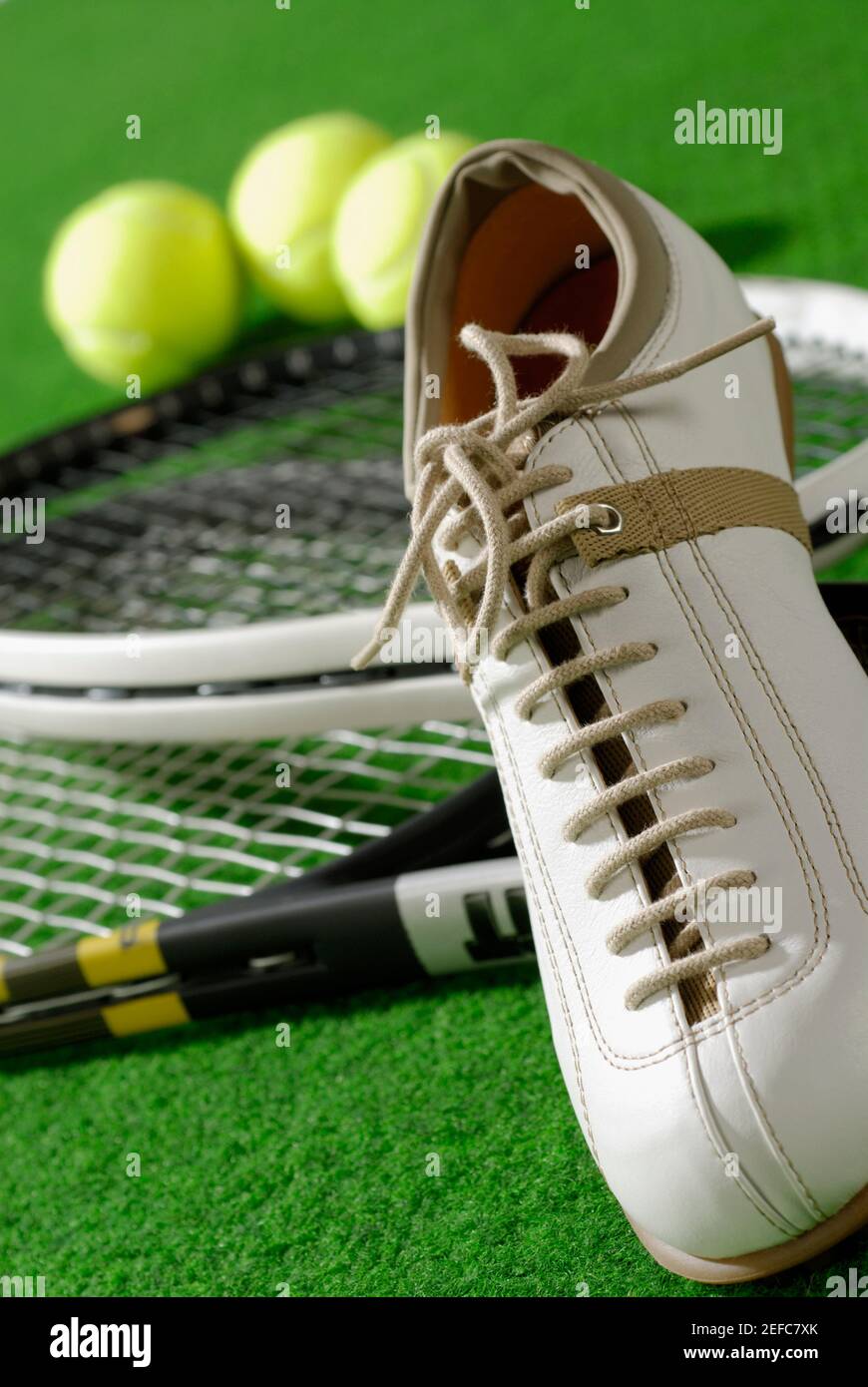 Close-up of a tennis shoe with tennis rackets and tennis balls Stock ...