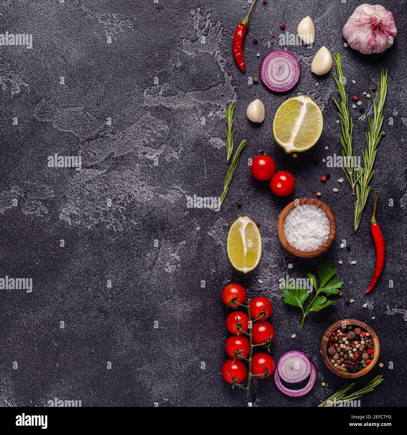 Herbs and condiments on black stone background. Top view with copy ...