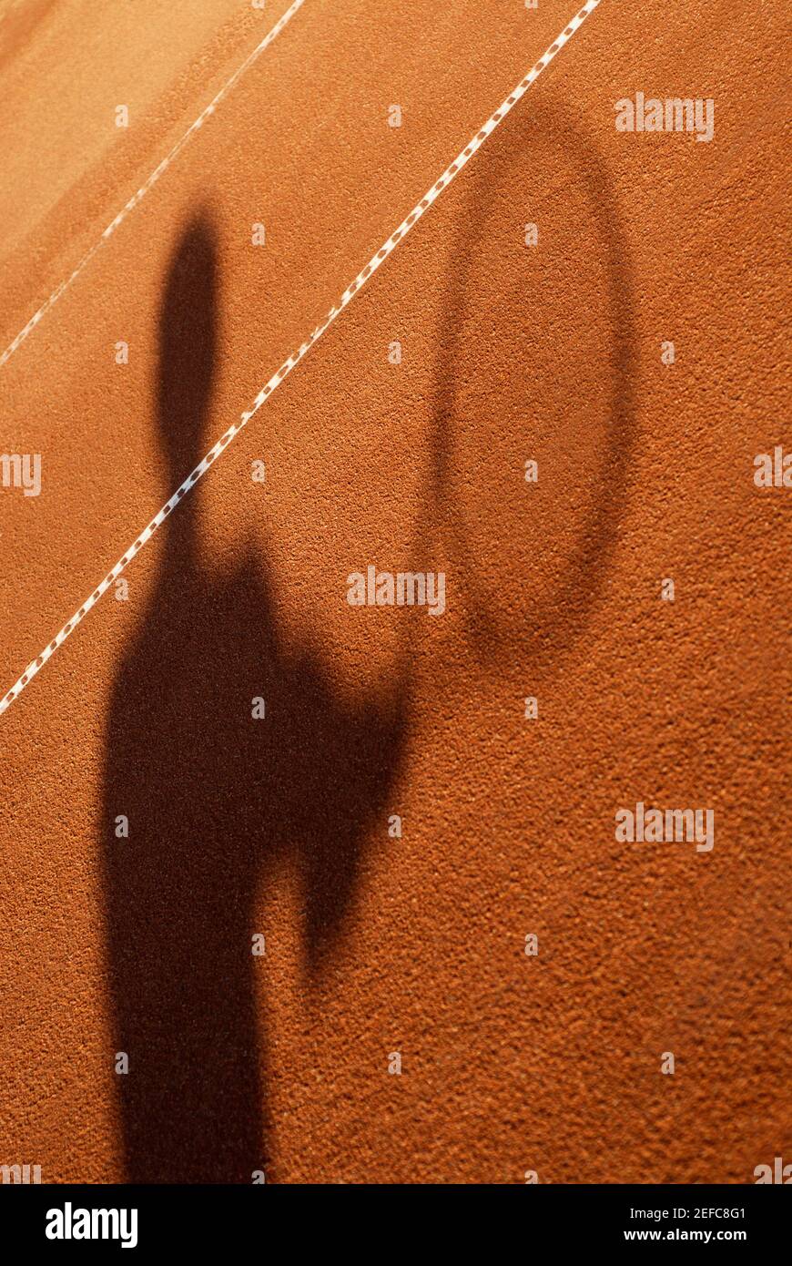 Shadow of a person holding a tennis racket Stock Photo