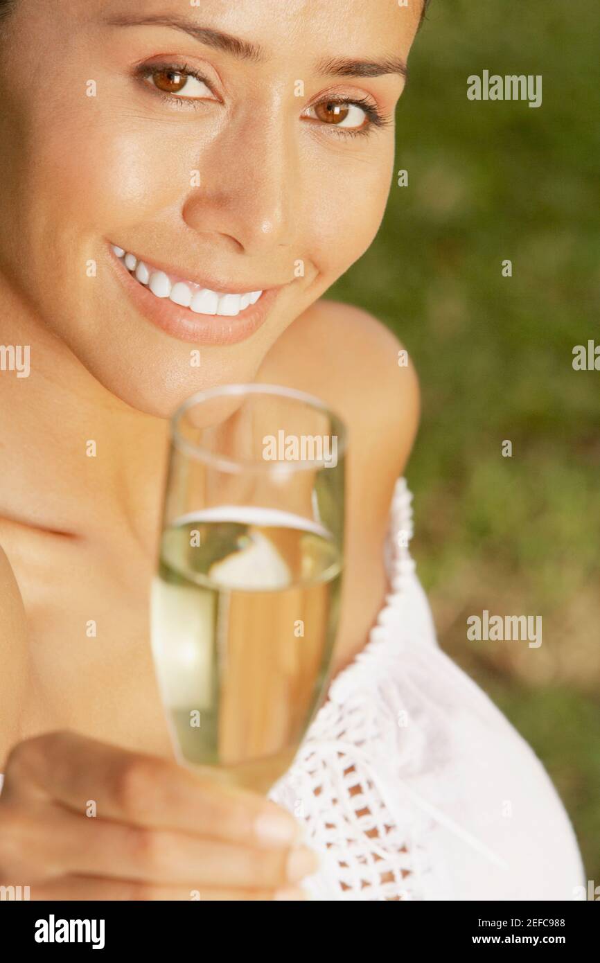 Portrait of a young woman holding a champagne flute Stock Photo