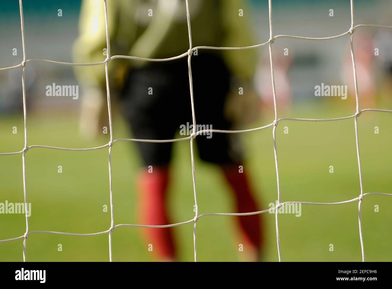 Mid section view of a goalie standing at the goal post Stock Photo Alamy