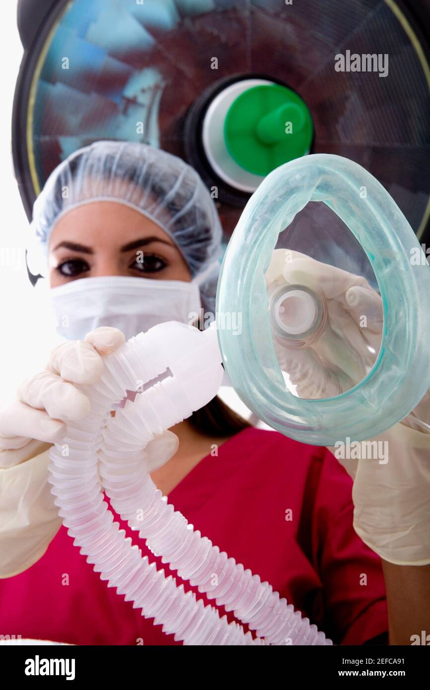 Low angle view of a female surgeon holding an oxygen mask Stock Photo ...